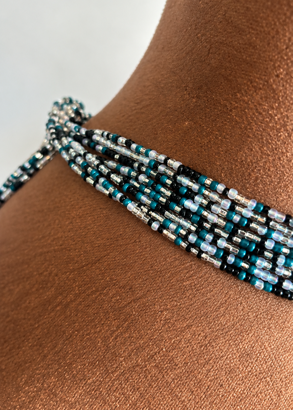 Close-up of Midnight Rain waist beads worn at the waist