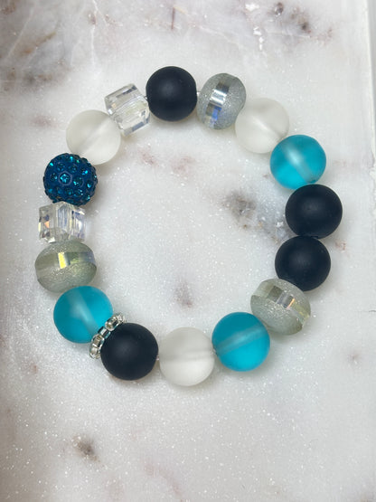 Velvet Tide bracelet with black, frosted white, aqua, and silver-toned beads and teal crystal accents.