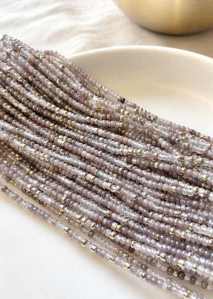 Heaven gray, clear, and silver waist beads arranged across a white dish