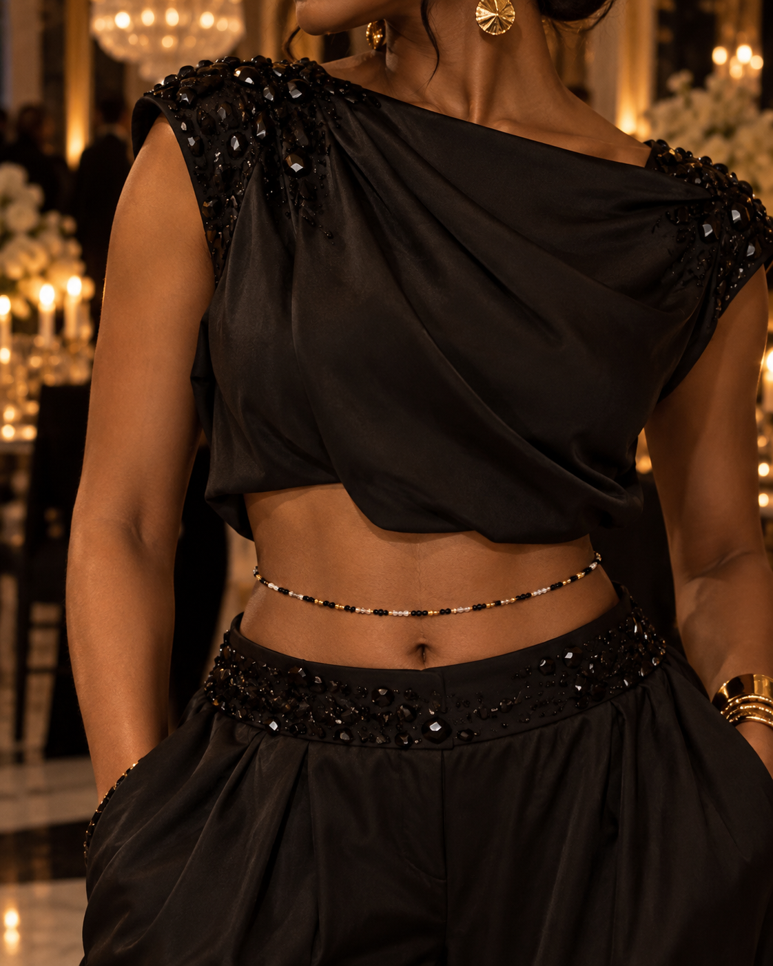 Model wearing Gilded Noir black, clear, and gold waist beads with a black outfit
