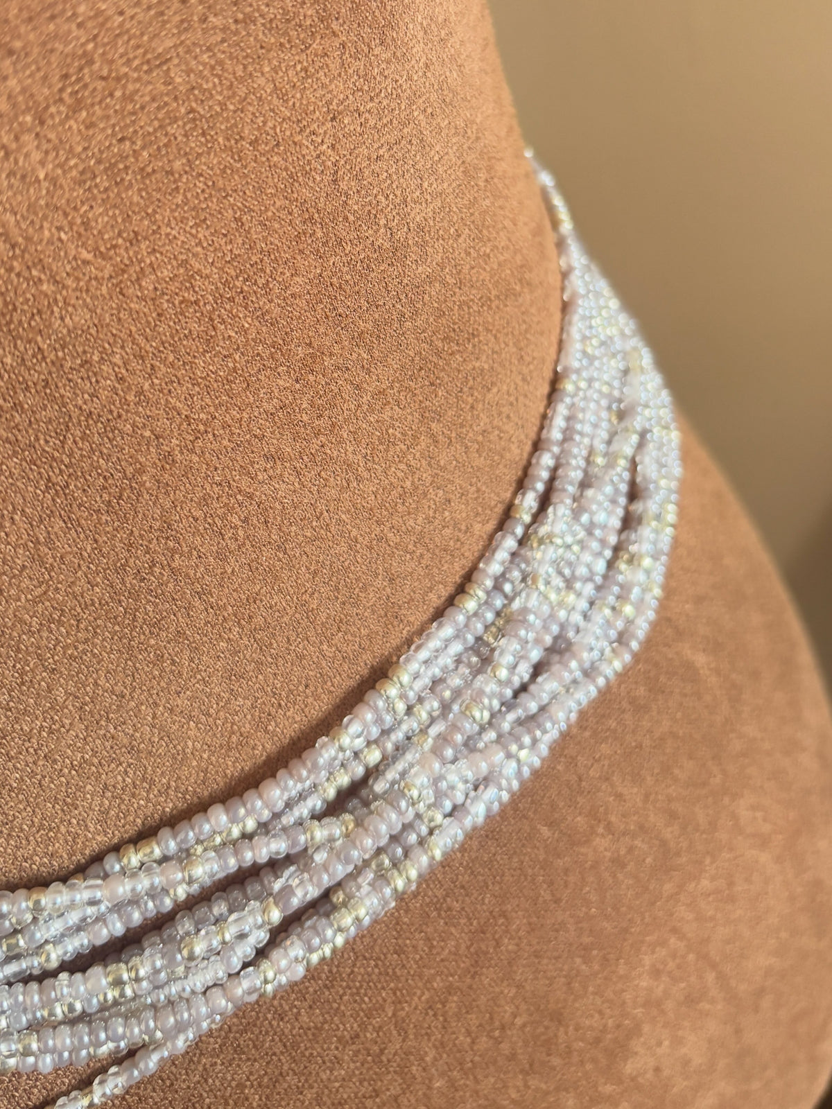 Close-up of Heaven gray and silver waist beads worn around the waist