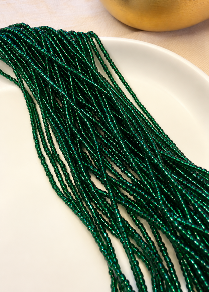 Eden deep emerald green waist beads draped across a white dish