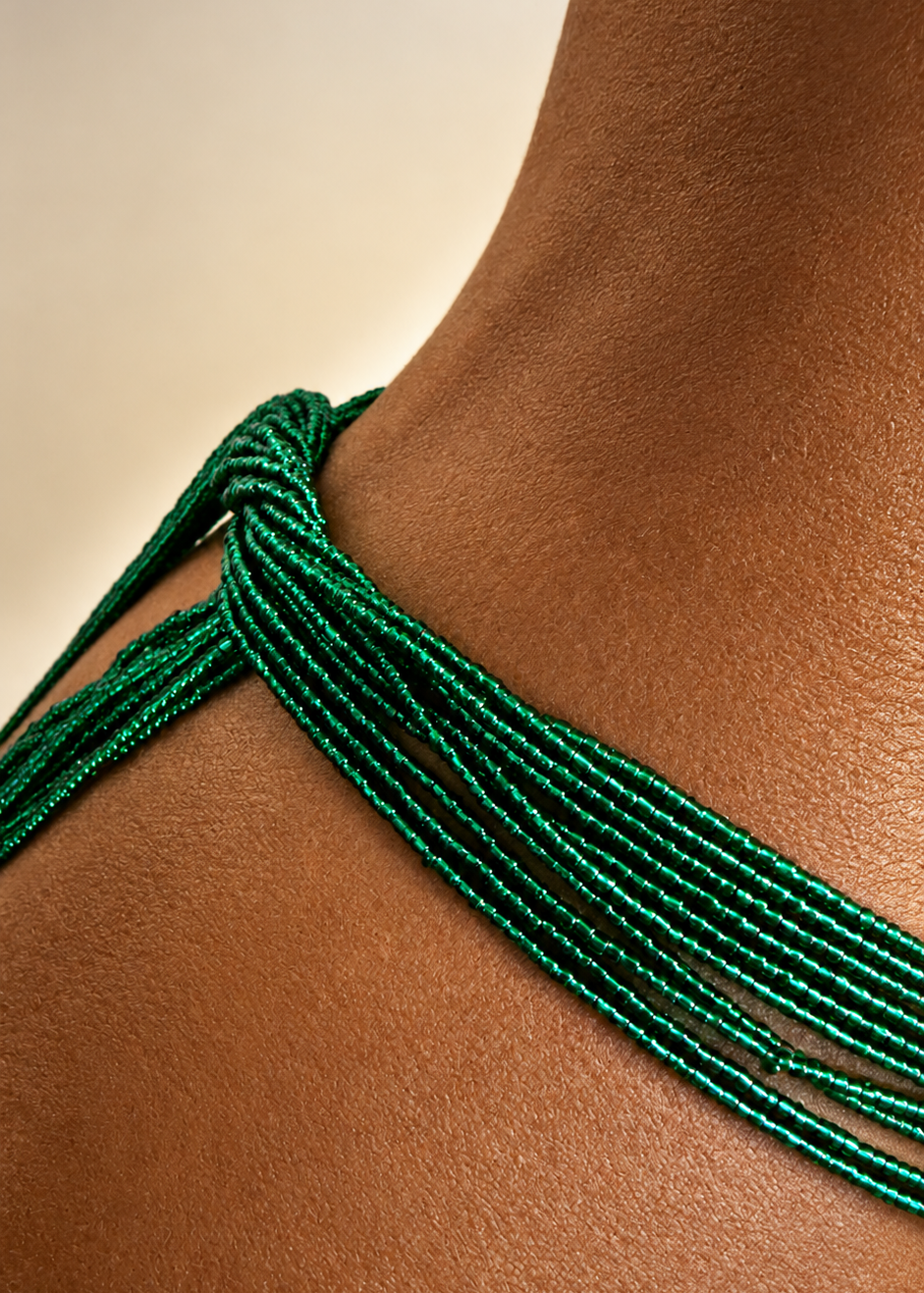 Close-up of Eden emerald green waist beads tied around the waist