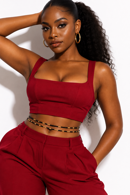 Model wearing black and gold Obaa Sima waist beads with a red outfit
