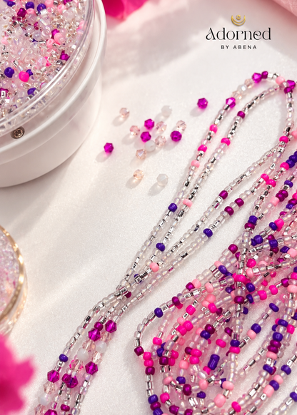 Pink Reign Luxe waist beads displayed beside a bowl of beads with Adorned by Abena branding
