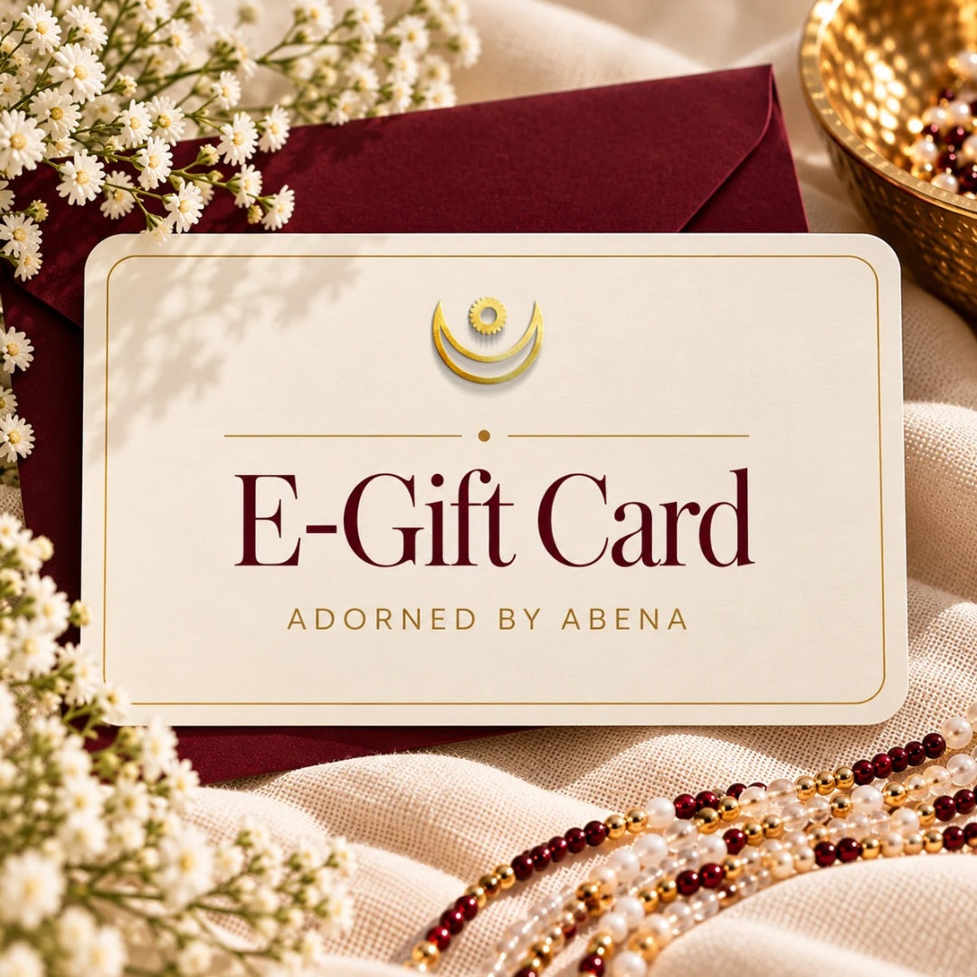 Adorned by Abena ivory E-Gift Card with gold border, burgundy envelope, baby's breath, and waist beads